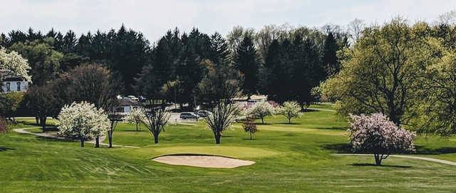 A spring day view of a hole at Elms Country Club.