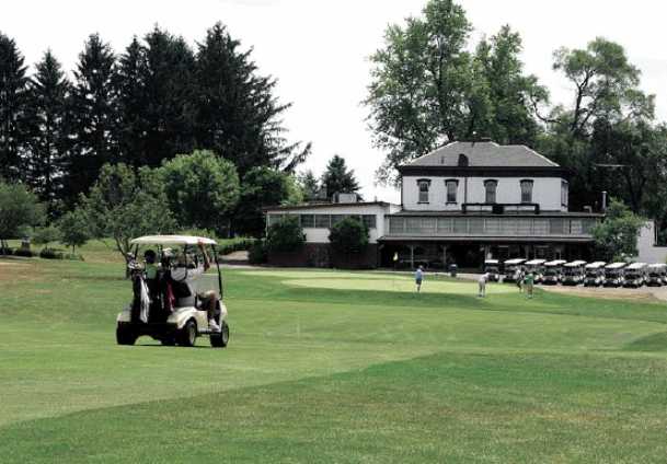 A view of a green and the clubhouse at Elms Country Club.