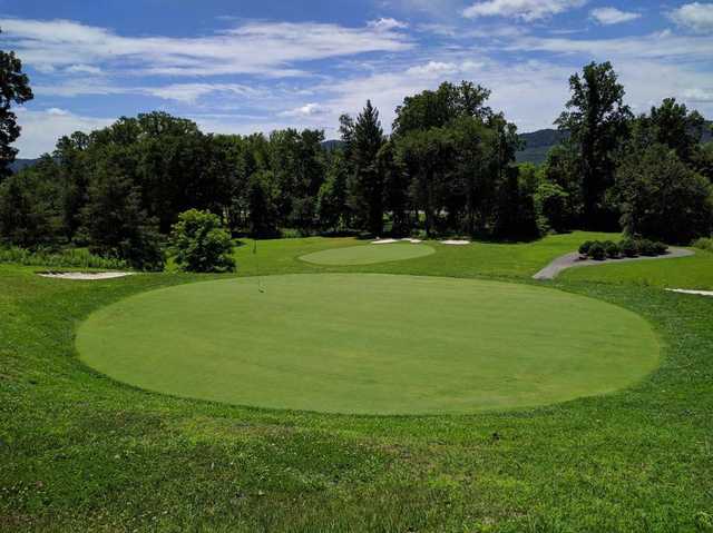 A sunny day view of two greens at  Middlesboro Country Club .