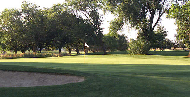 A sunny day view of a green at Mather Golf Course.
