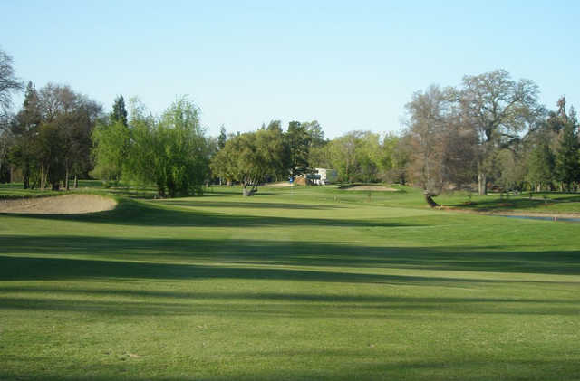 A sunny day view of a green at Dry Creek Ranch Golf Course.