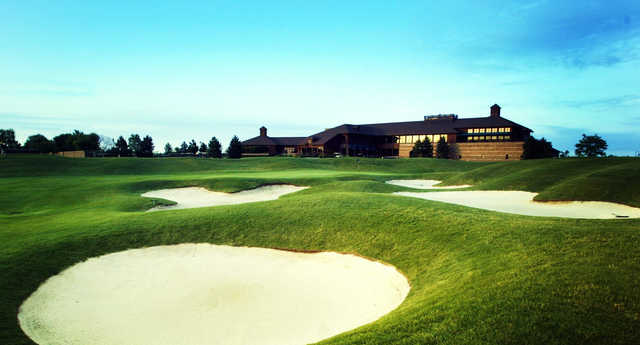 A view of a well protected hole and the clubhouse at Lakes of Taylor Golf Club.