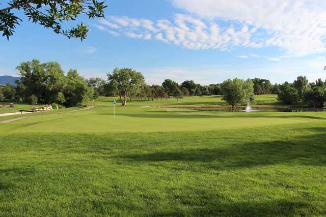 A sunny day view of a green at Patty Jewett Golf Course.