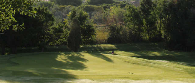A sunny day view of a green at Valley Hi Municipal Golf Course.
