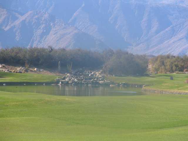 Mountains loom overhead and a waterfall rushes on No. 16.