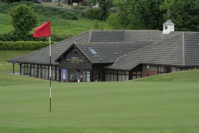 View of a green and the clubhouse at South Chesterfield Golf Club