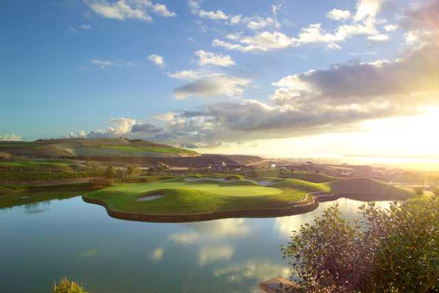 A view of a green surrounded by water at Arrowood Golf Course.