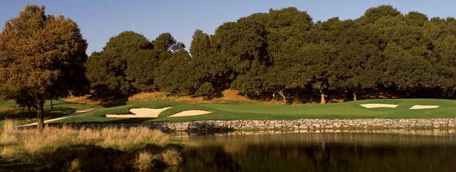 A view of a green surrounded by bunkers and water at Peacock Gap Golf Club