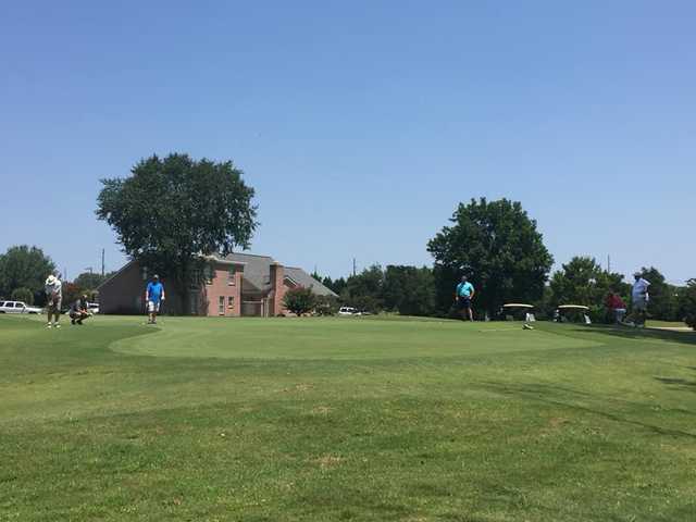 A sunny day view of a green at River Birch Golf Club.