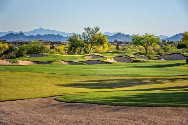 A sunny day view of a hole protected by a collection of bunkers from Palmer Course at Wildfire Golf Club at Desert Ridge.