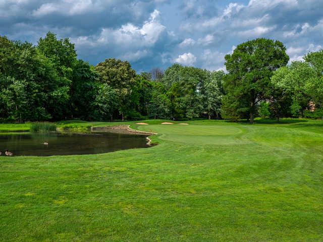 A view of the 10th hole with water guarding front and left sides at South at Woodmont Country Club