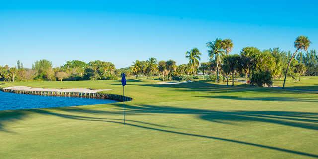 A sunny day view of a hole at Palm Beach National Golf Course.