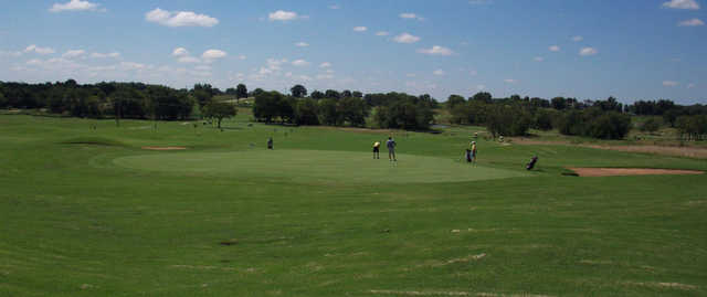 A sunny day view of a green at Peoria Ridge.