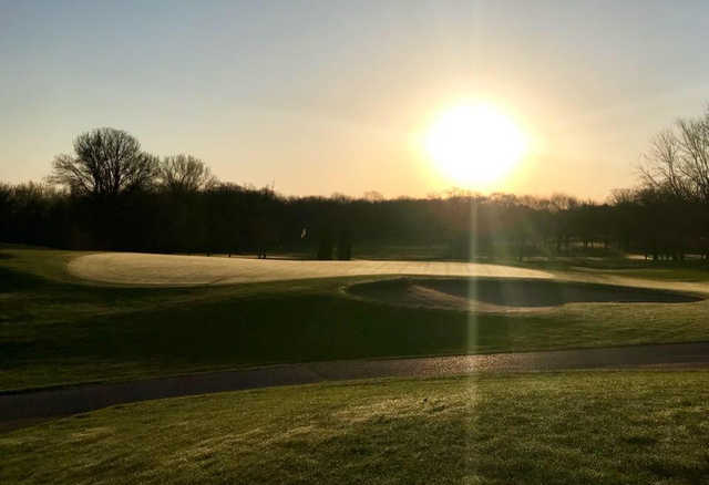 A sunny day view of a green at Mascoutin Golf Club.