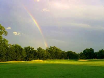A view of a rainbow over the 7th green at Sunset Golf Club