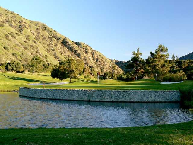 A view of a challenging green surrounded by water at San Dimas Canyon Golf Course.