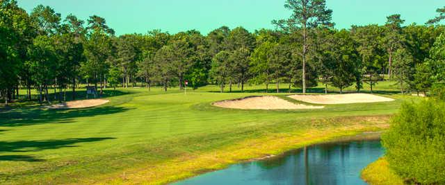 A view of a green surrounded by bunkers at Harbor Pines Golf Club.