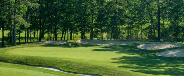 A view of a green protected by bunkers at Harbor Pines Golf Club.