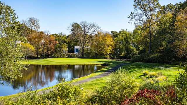 A fall day view of a green at Oak Hills Park Golf Course.