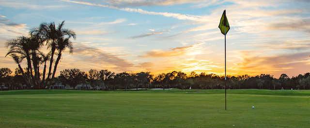 A sunset view of a hole at Heritage Oaks Golf & Country Club.