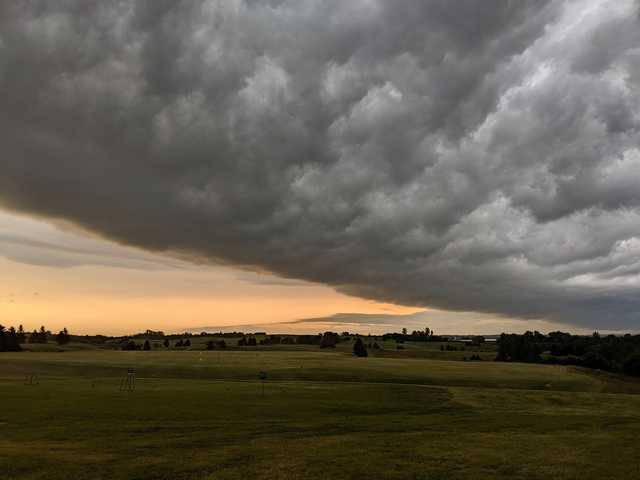 A view of the driving range covered by dark clouds at Gopher Hills Golf Course.