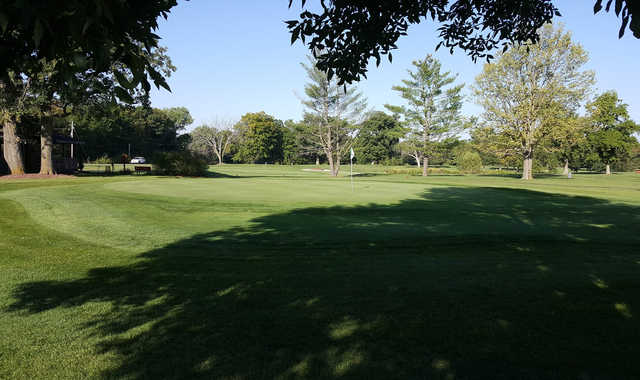 A sunny day view of a hole at Woodland Hills Golf Course.