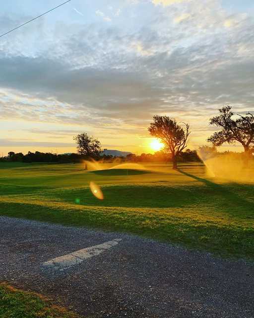 Sunset view of hole #7 at The Greens of Altus Golf Course.