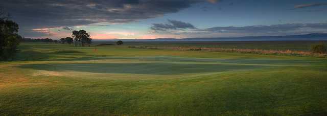 A cloudy day view of a green at Heswall Golf Club.