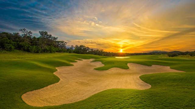 A sunset view of green #8 at Kissing Tree Golf Club.