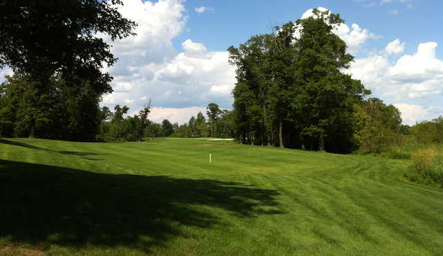 A sunny day view of a fairway at Refuge Golf Club.