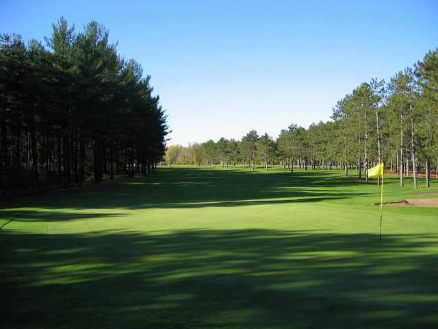 A sunny day view of a green at New Richmond Golf Club.