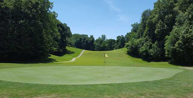 A sunny day view of a hole at John James Audubon Golf Course.
