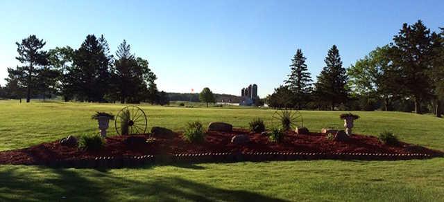 A sunny day view of a green at RiverEdge Golf Course.