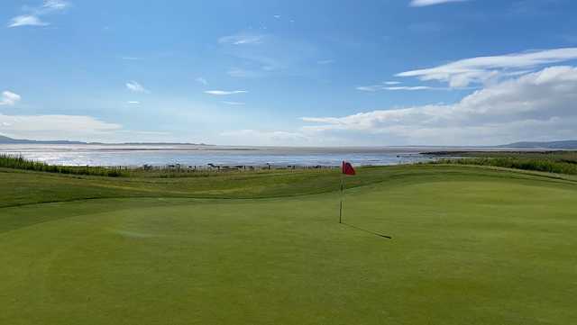 A sunny day view of a green at Machynys Peninsula Golf & Country Club.