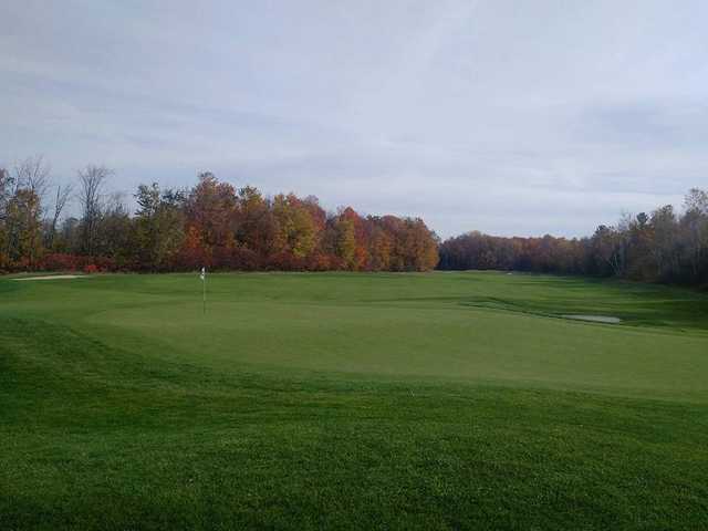 A fall day view of a green at Batteaux Creek Golf Club.