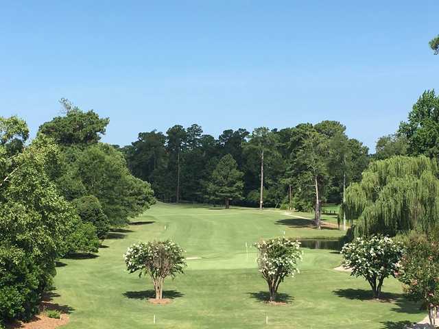 A view of a green guarded by a pond at Washington Yacht & Country Club.
