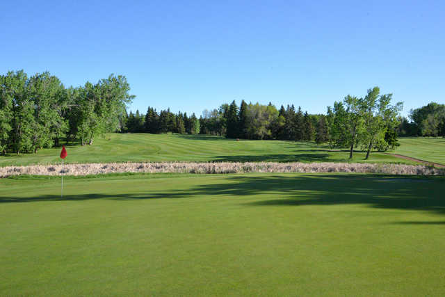 A sunny day view of a hole at Camrose Golf Course.