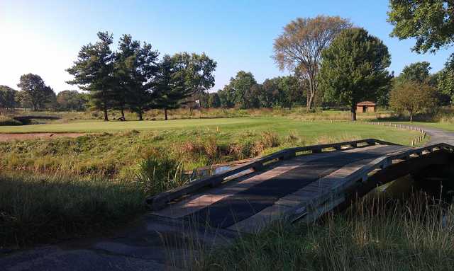 A sunny day view of a green at Bonnie Brook Golf Course.