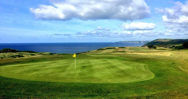 A view of a green with water in background at Whitsand Bay Golf Club.