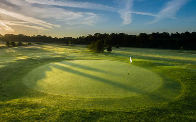 A sunset view of a green at Test Valley Golf Club.
