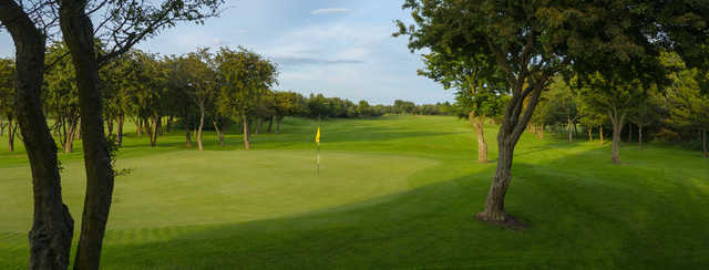 A sunny day view of hole #14 at Blyth Golf Club.