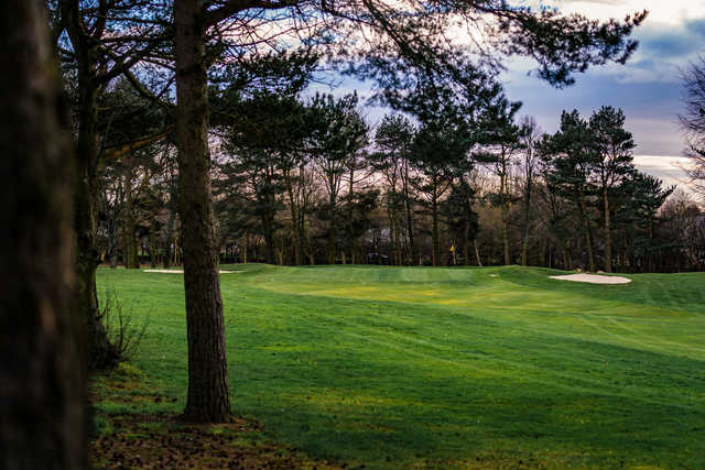 A view of a green flanked by bunkers at Westerhope Golf Club.