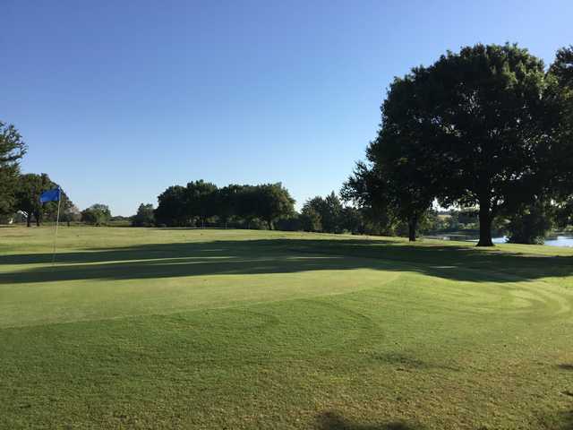 A sunny day view of a green at Waxahachie Golf Club.