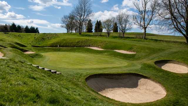 A view of a green surrounded by bunkers at Dunstable Downs Golf Club.