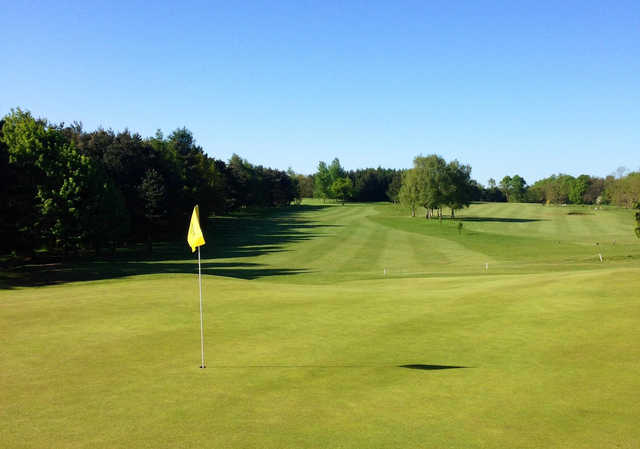 A sunny day view of a hole at The Millbrook Golf Club.