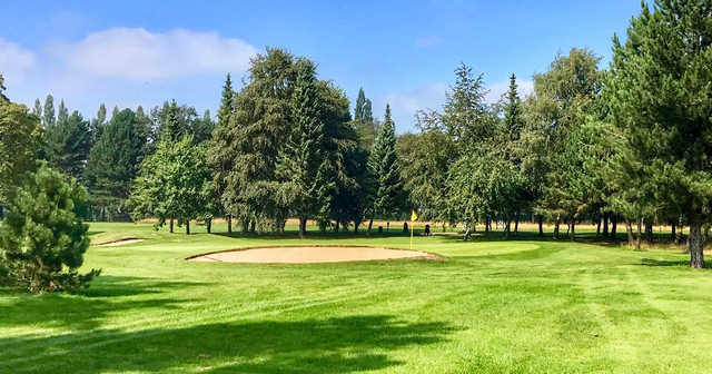 A sunny day view of a hole at Leigh Golf Club.