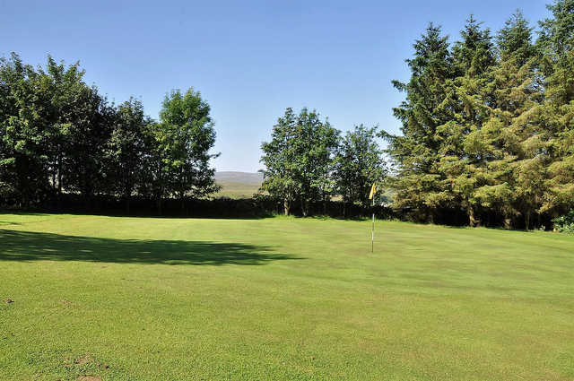 A sunny day view of a hole at Alston Moor Golf Club.