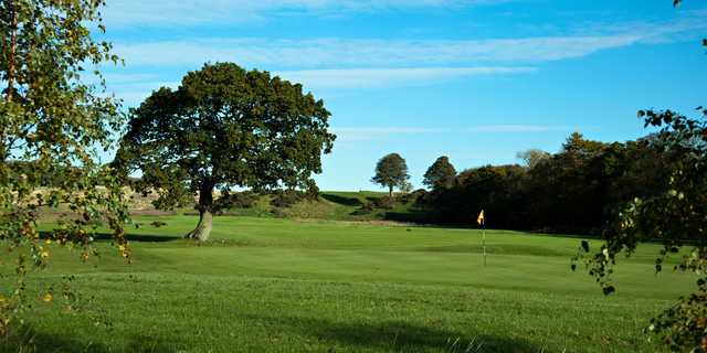 A sunny day view of a hole at Hadrians Course from Eden Golf Club.