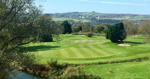 A sunny day view of a green at Dinnaton Golf Club.