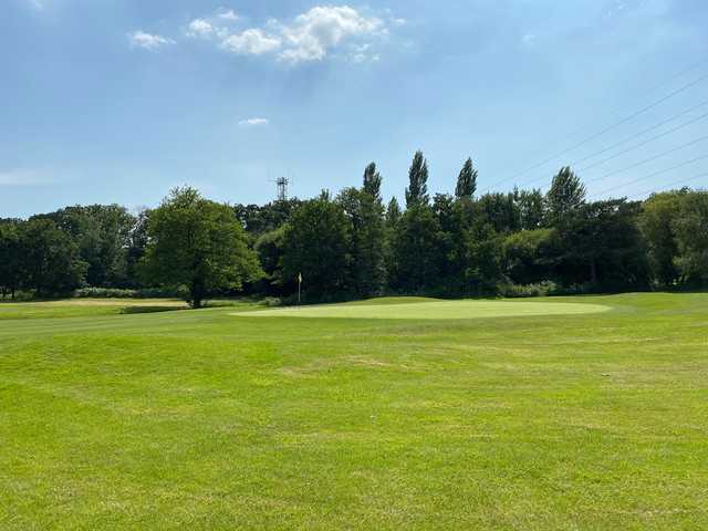 A summer day view of a hole at Ferndown Forest Golf Club.